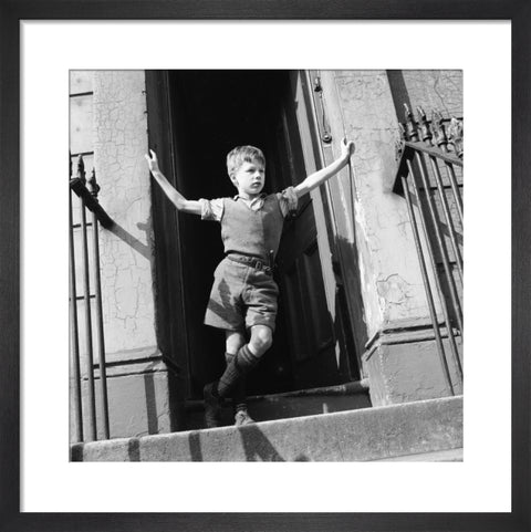 Boy standing in open doorway 1957