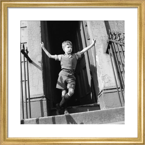 Boy standing in open doorway 1957