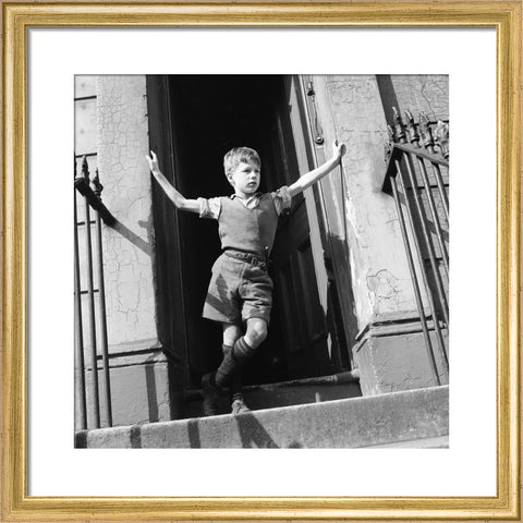 Boy standing in open doorway 1957