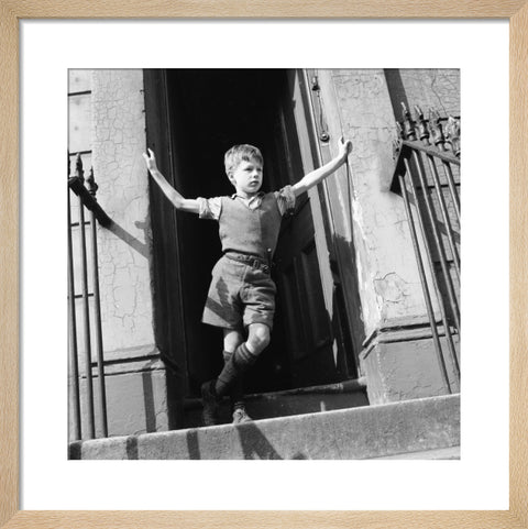 Boy standing in open doorway 1957