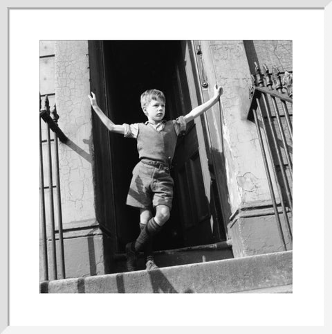 Boy standing in open doorway 1957