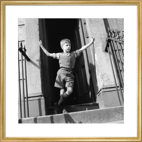 Boy standing in open doorway 1957