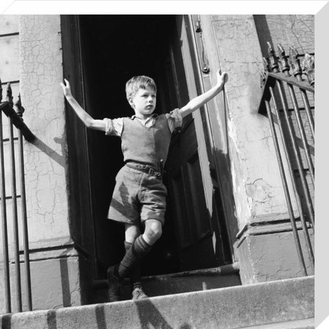 Boy standing in open doorway 1957