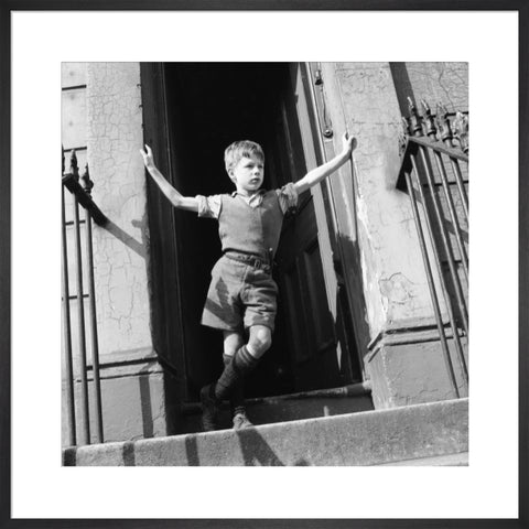 Boy standing in open doorway 1957