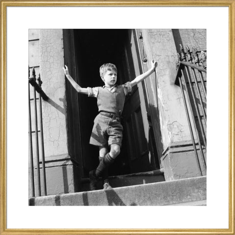 Boy standing in open doorway 1957