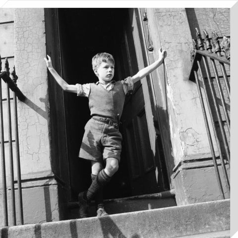 Boy standing in open doorway 1957