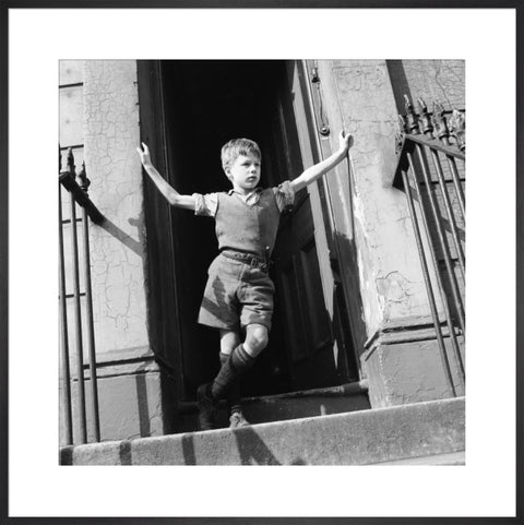 Boy standing in open doorway 1957