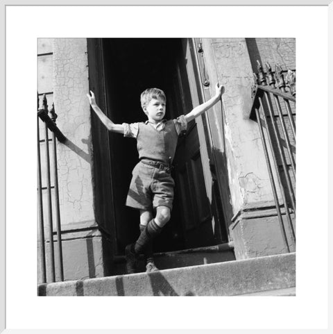 Boy standing in open doorway 1957