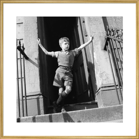 Boy standing in open doorway 1957