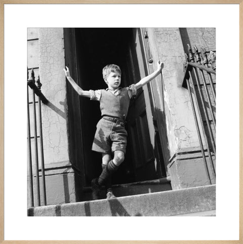 Boy standing in open doorway 1957