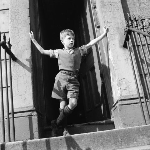 Boy standing in open doorway 1957