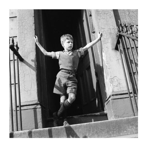 Boy standing in open doorway 1957