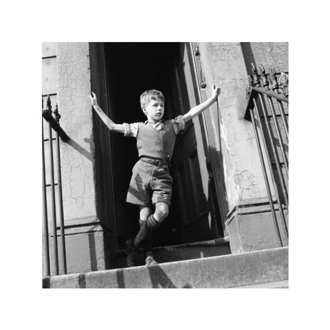 Boy standing in open doorway 1957