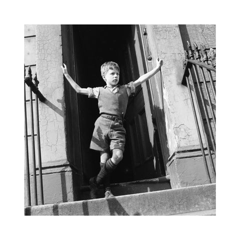 Boy standing in open doorway 1957