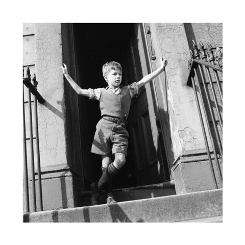 Boy standing in open doorway 1957