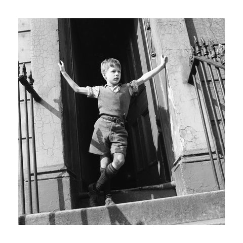 Boy standing in open doorway 1957