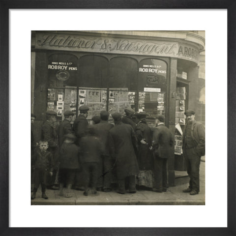 A crowd gathered around an East End newsagents window display c.1900