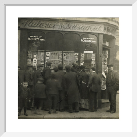 A crowd gathered around an East End newsagents window display c.1900