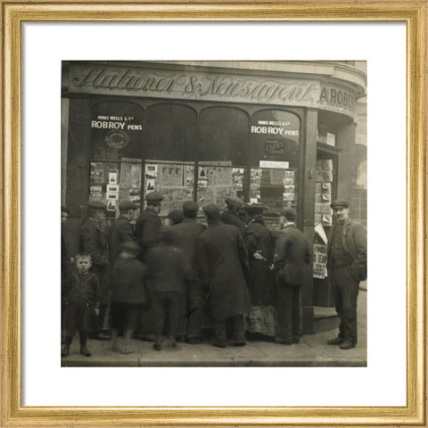 A crowd gathered around an East End newsagents window display c.1900