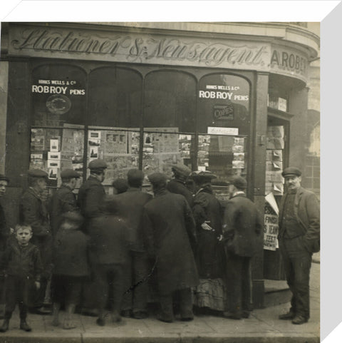 A crowd gathered around an East End newsagents window display c.1900