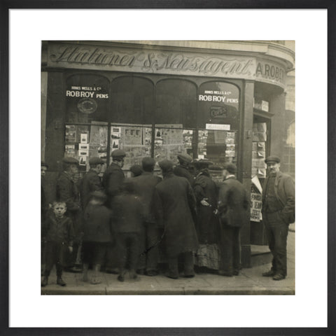 A crowd gathered around an East End newsagents window display c.1900