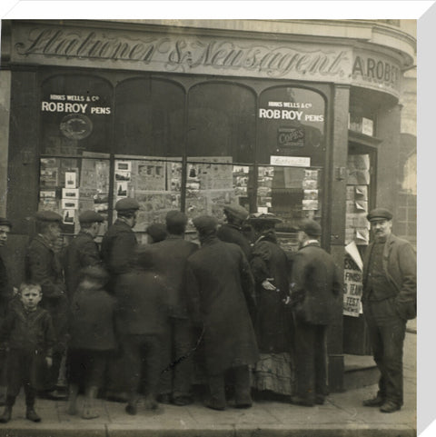 A crowd gathered around an East End newsagents window display c.1900