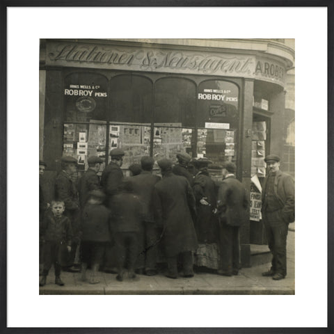 A crowd gathered around an East End newsagents window display c.1900