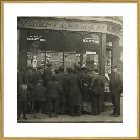 A crowd gathered around an East End newsagents window display c.1900