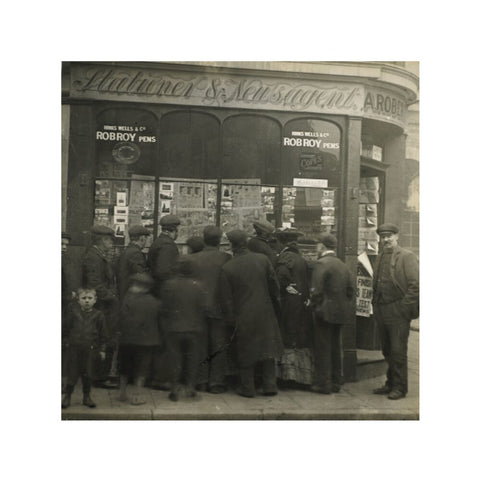 A crowd gathered around an East End newsagents window display c.1900