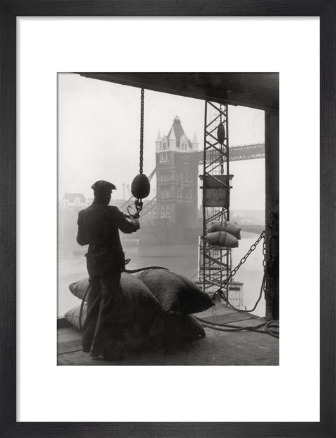 Pool of London Dockworker handling a cargo of bagged nuts 1947