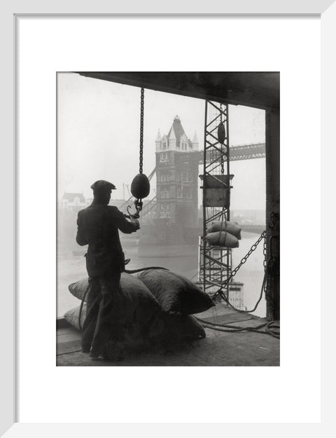 Pool of London Dockworker handling a cargo of bagged nuts 1947