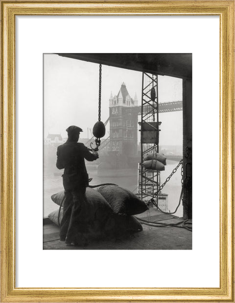 Pool of London Dockworker handling a cargo of bagged nuts 1947
