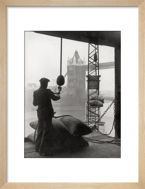 Pool of London Dockworker handling a cargo of bagged nuts 1947
