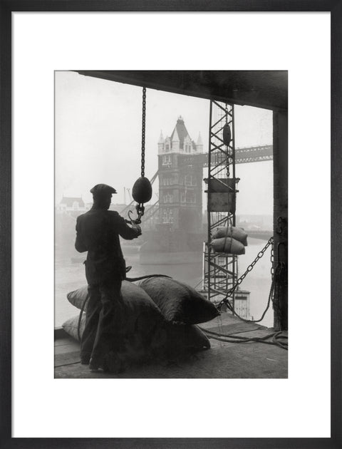 Pool of London Dockworker handling a cargo of bagged nuts 1947
