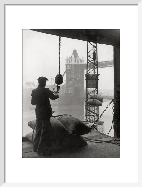 Pool of London Dockworker handling a cargo of bagged nuts 1947