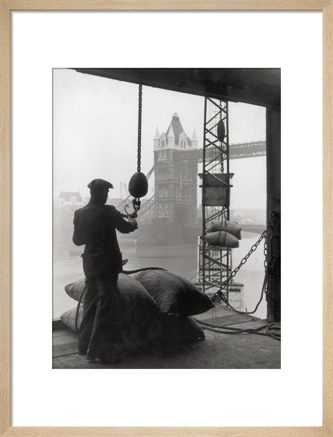 Pool of London Dockworker handling a cargo of bagged nuts 1947