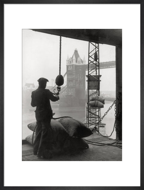 Pool of London Dockworker handling a cargo of bagged nuts 1947