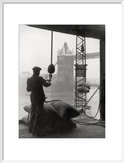 Pool of London Dockworker handling a cargo of bagged nuts 1947