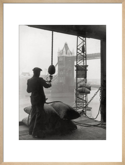 Pool of London Dockworker handling a cargo of bagged nuts 1947