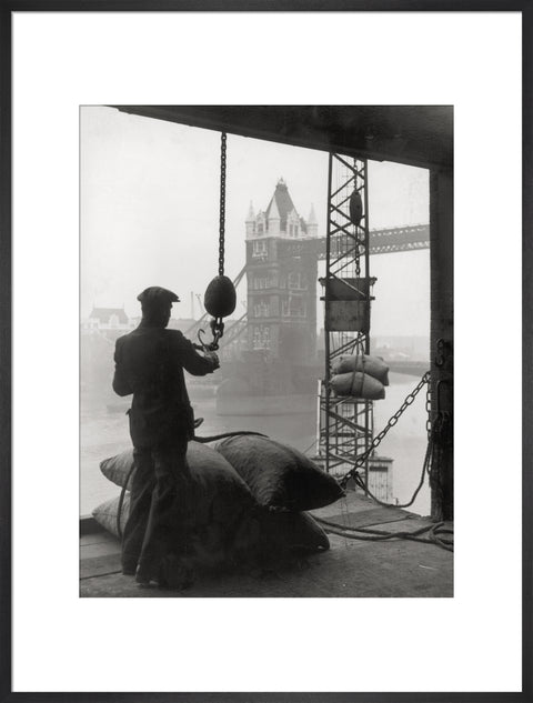 Pool of London Dockworker handling a cargo of bagged nuts 1947