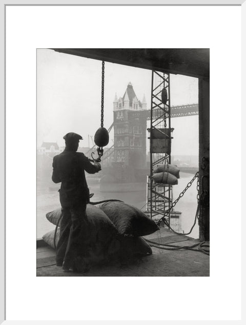 Pool of London Dockworker handling a cargo of bagged nuts 1947
