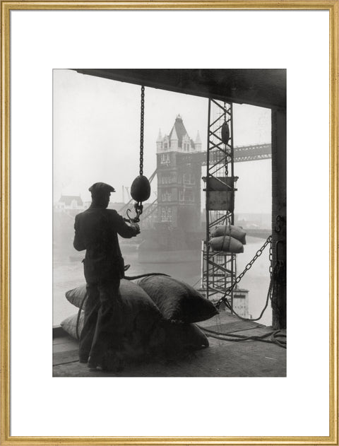 Pool of London Dockworker handling a cargo of bagged nuts 1947