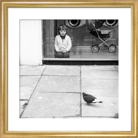 Boy watching a pigeon in Boreham Wood c.1965