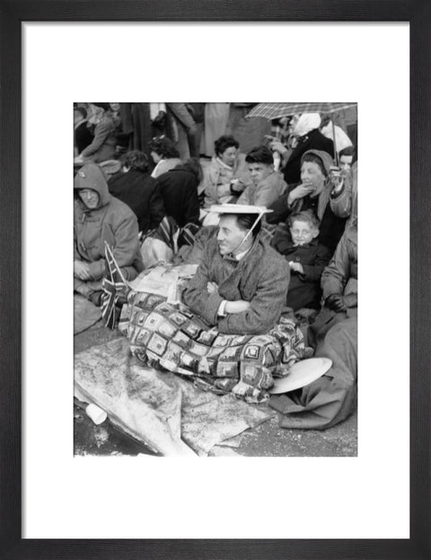 Spectators waiting on the pavement for Queen Elizabeth II's Coronation 1953