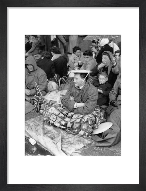 Spectators waiting on the pavement for Queen Elizabeth II's Coronation 1953