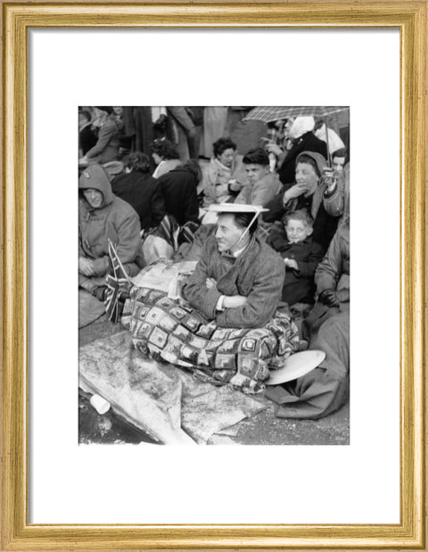 Spectators waiting on the pavement for Queen Elizabeth II's Coronation 1953