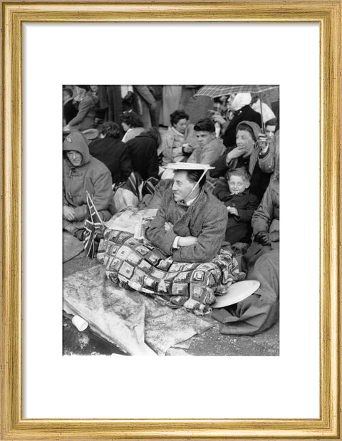 Spectators waiting on the pavement for Queen Elizabeth II's Coronation 1953