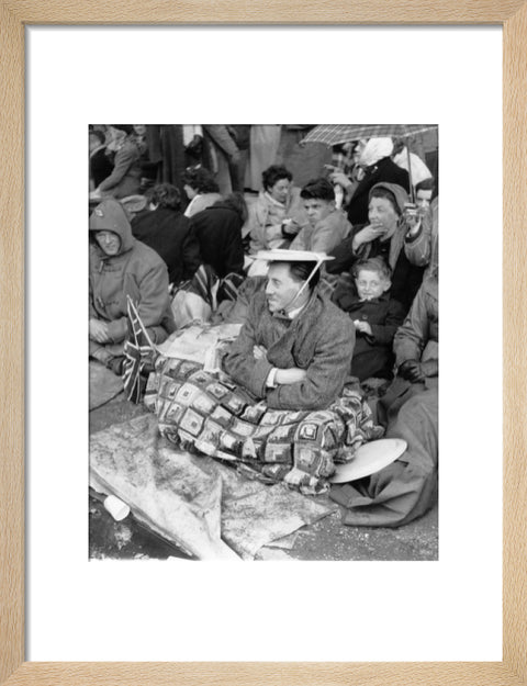 Spectators waiting on the pavement for Queen Elizabeth II's Coronation 1953