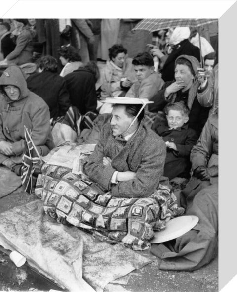 Spectators waiting on the pavement for Queen Elizabeth II's Coronation 1953