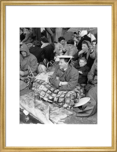 Spectators waiting on the pavement for Queen Elizabeth II's Coronation 1953